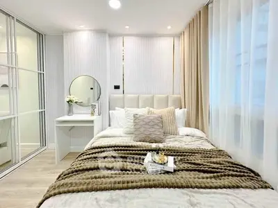 Elegant bedroom with plush bedding and modern decor, featuring a cozy ambiance and stylish design.