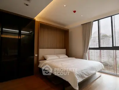Modern bedroom with large window and stylish decor in luxury apartment