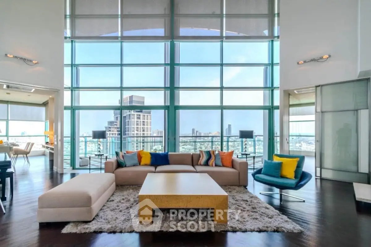 Luxurious high-rise living room with floor-to-ceiling windows and stunning city views.