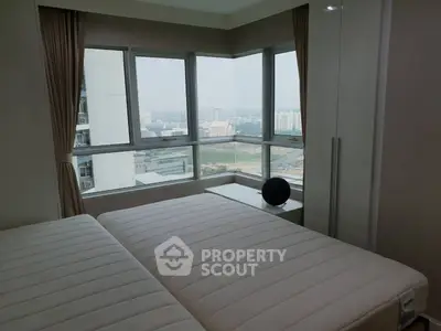 Spacious bedroom with panoramic city view and modern furnishings
