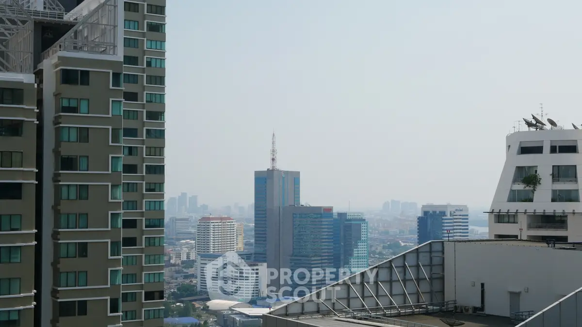 Stunning cityscape view from high-rise building balcony, showcasing urban skyline and architectural diversity.