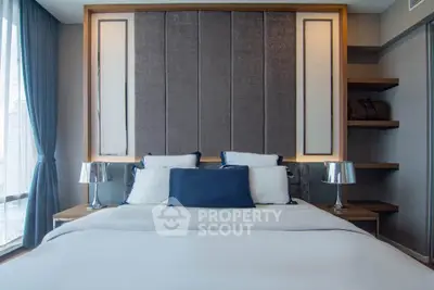 Luxurious bedroom with elegant decor and plush bedding in a modern apartment.