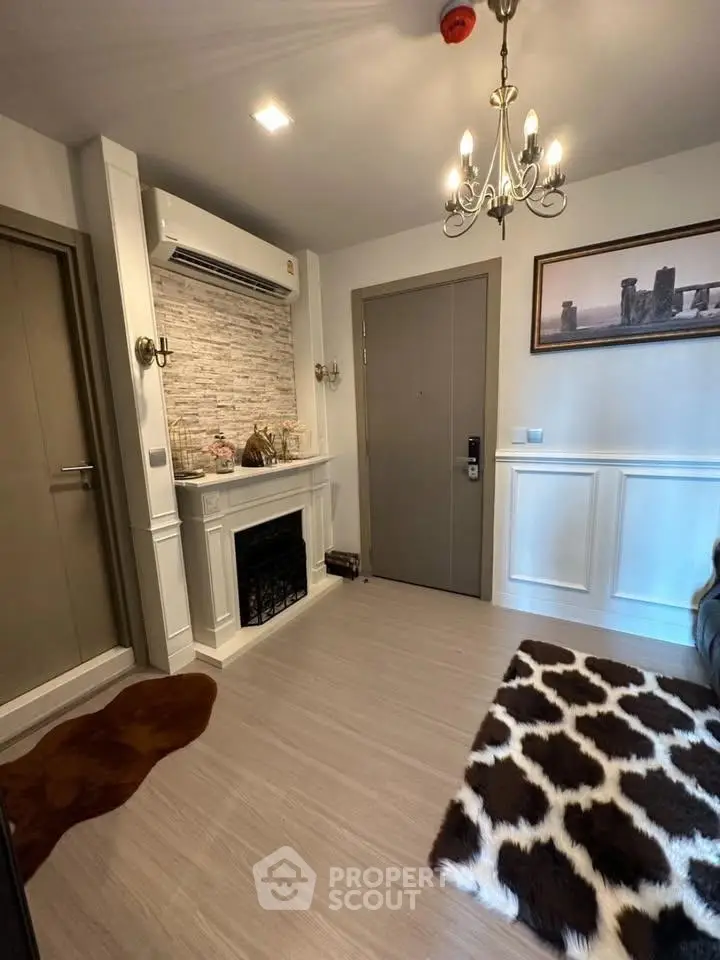 Charming entryway with faux fireplace and elegant decor in modern apartment.