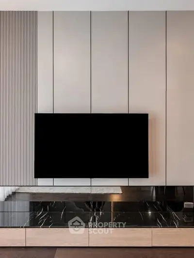 Modern living room with sleek TV setup and elegant marble accents