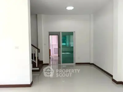 Spacious modern interior with glossy floors and staircase, ideal for customization.