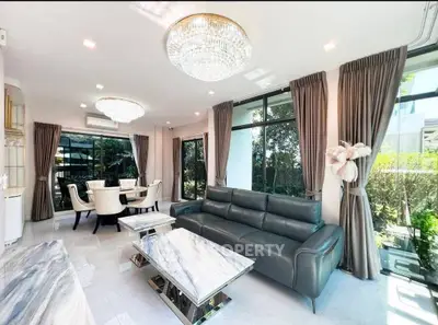 Luxurious living room with elegant decor, large windows, and modern furniture in a bright, spacious setting.