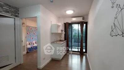 Modern apartment interior with compact kitchen and balcony view