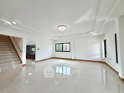 Spacious modern living room with elegant ceiling design and natural light