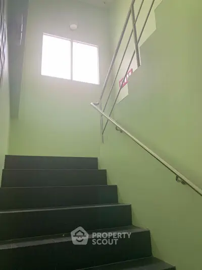 Bright stairwell with modern railing and natural light