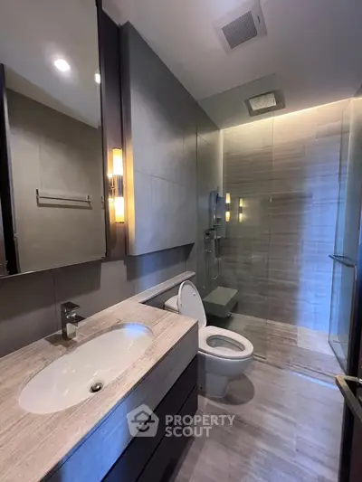 Modern bathroom with sleek fixtures and spacious shower area
