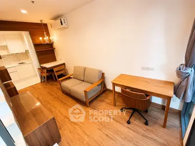 Modern living room with wooden flooring, cozy sofa, and study desk in a stylish apartment.