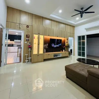 Spacious modern living room with built-in entertainment center and sleek design.