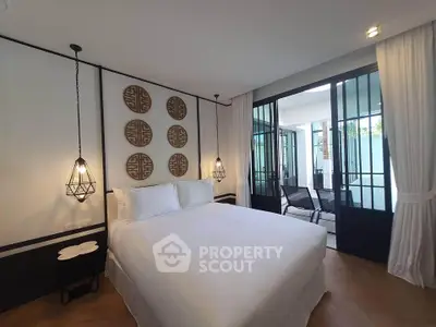 Luxurious bedroom with elegant decor and access to a private balcony, perfect for relaxation.
