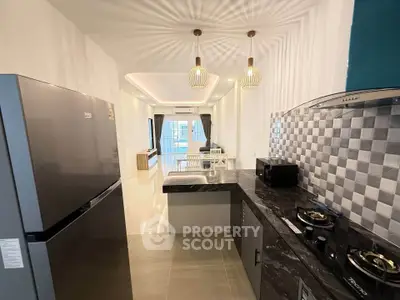 Modern kitchen with open layout and stylish lighting in a contemporary apartment.