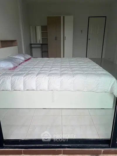 Spacious bedroom with modern furnishings and ample storage space, perfect for comfortable living.