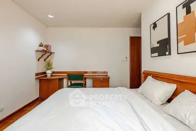 Cozy bedroom with wooden furniture and modern art decor