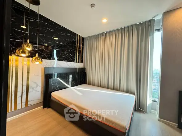 Luxurious modern bedroom with stylish decor and large window offering stunning city views.