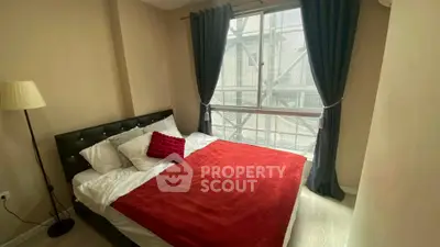 Cozy bedroom with large window and stylish decor in modern apartment