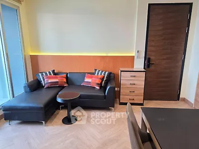 Modern living room with stylish black sofa and chic decor in a contemporary apartment.
