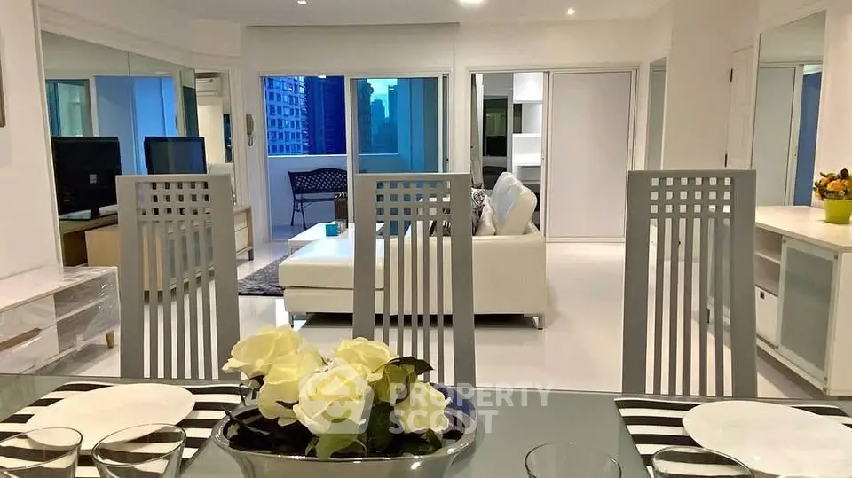 Luxurious open-plan living room with modern decor and city view, perfect for urban living.