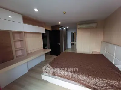 Spacious bedroom with modern design and ample storage in a luxury apartment.