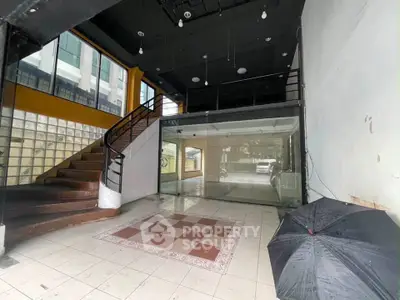 Spacious commercial space with mezzanine and large windows for lease.