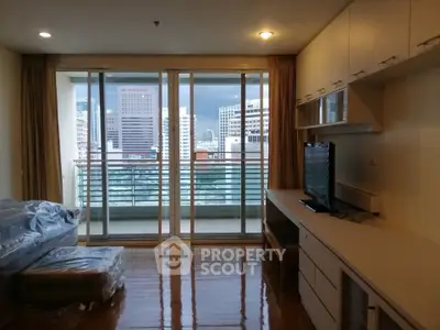 Spacious living room with city view and modern built-in furniture