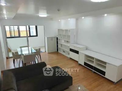 Spacious modern living room with sleek furniture and wooden flooring