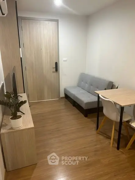 Cozy modern living room with wooden flooring and minimalist furniture