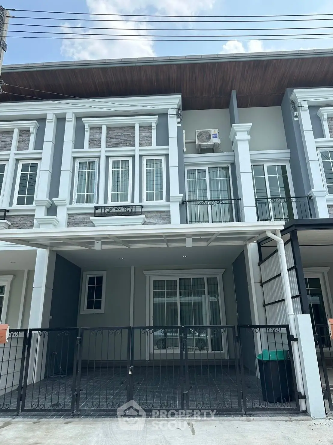 Modern townhouse exterior with gated parking and stylish facade