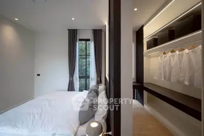 Modern bedroom with walk-in closet and elegant decor
