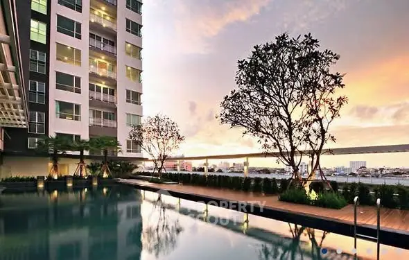 Luxurious high-rise apartment with stunning pool and sunset view.