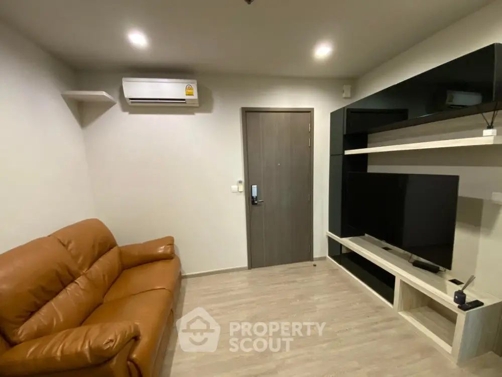 Modern living room with leather sofa and wall-mounted TV unit