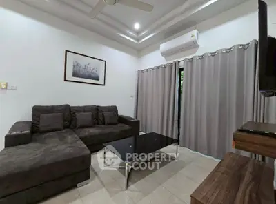 Modern living room with stylish furniture and air conditioning, perfect for relaxation.