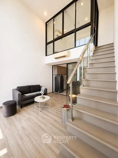 Modern duplex living room with high ceiling and stylish staircase