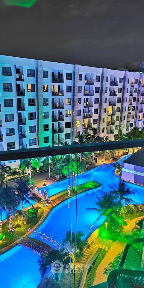 Stunning night view of illuminated pool and modern apartment building