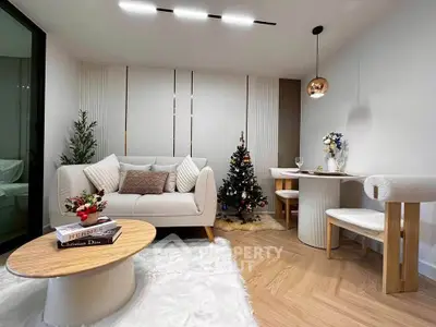 Stylish living room with modern decor and Christmas tree, featuring cozy seating and elegant dining area.