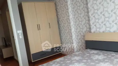 Modern bedroom with stylish wardrobe and geometric wallpaper design