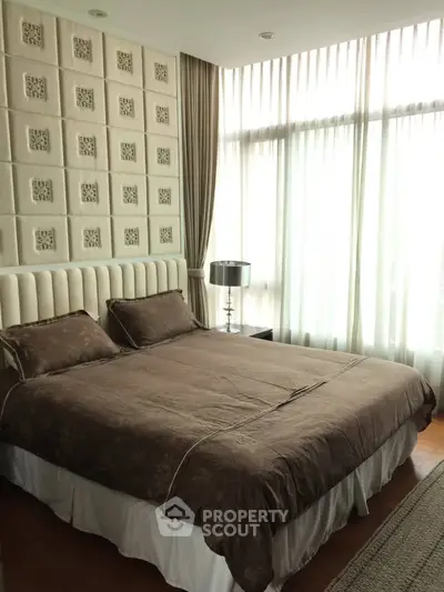 Luxurious bedroom with elegant decor and floor-to-ceiling windows