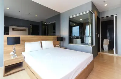 Modern bedroom with sleek design and ensuite bathroom in luxury apartment