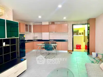 Spacious modern kitchen with open layout and sleek cabinetry in a contemporary apartment.