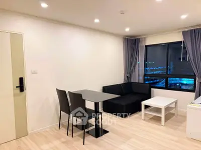 Modern living room with sleek furniture and large window view