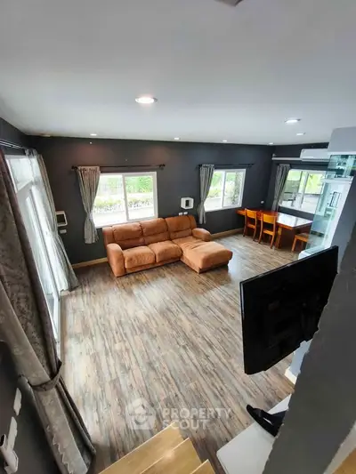 Spacious living room with modern decor and large windows for natural light.