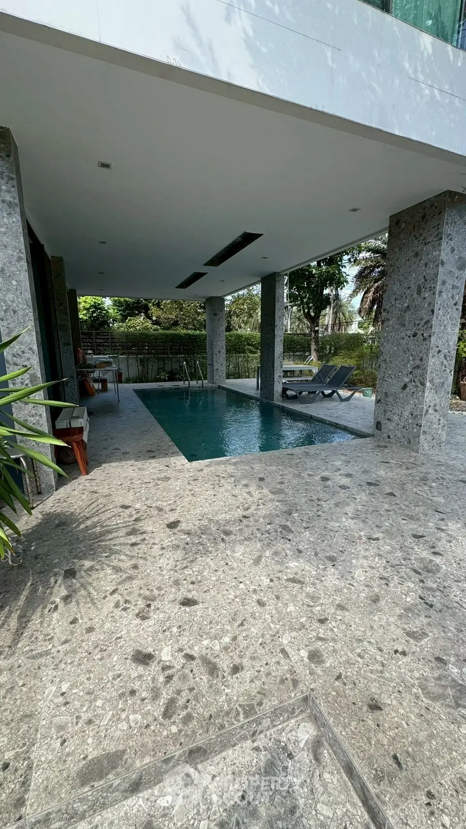 Luxurious outdoor pool area with modern design and lush greenery