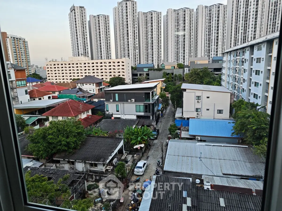 Urban residential view with high-rise buildings and diverse housing styles.