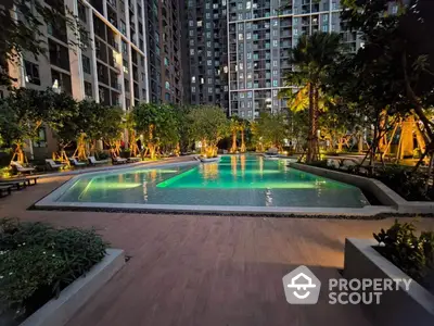 Luxurious residential pool area with ambient lighting and lush greenery