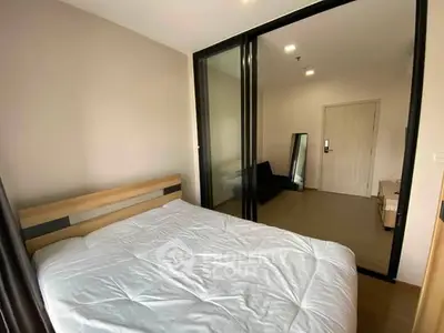 Modern bedroom with sliding glass doors and minimalist decor