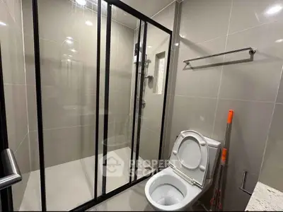 Modern bathroom with glass shower enclosure and sleek design