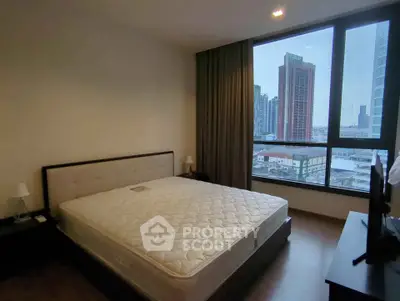 Spacious bedroom with city view in modern high-rise apartment