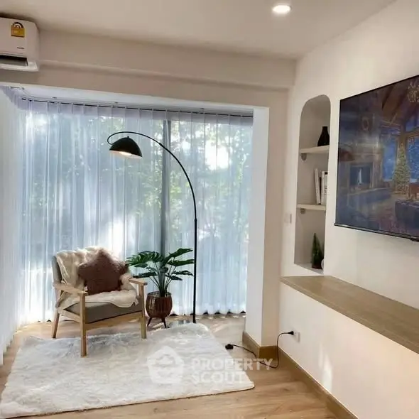 Cozy living room with modern decor and large window for natural light